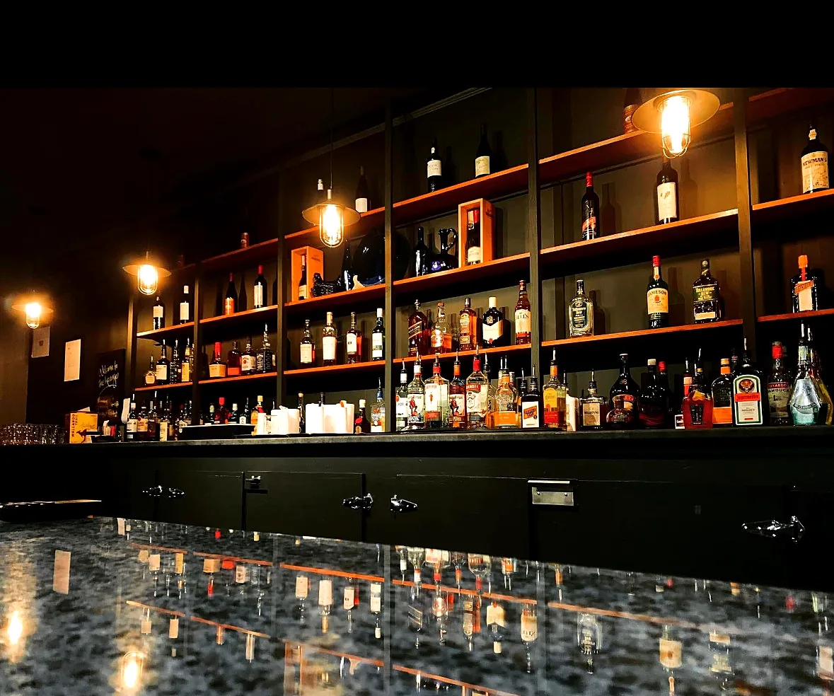 The lit back bar shelves and bottle selection at the Wabush Hotel bar