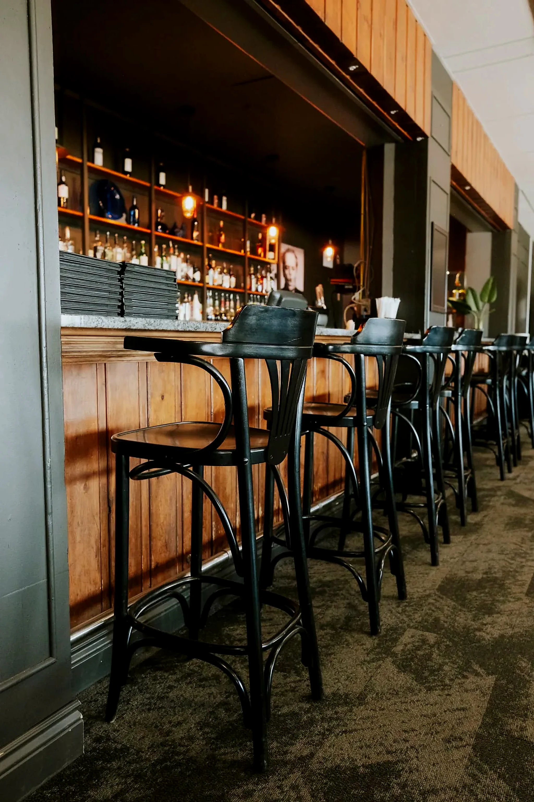 Stools lined along the hotel bar, open in the evening after a day outdoors
