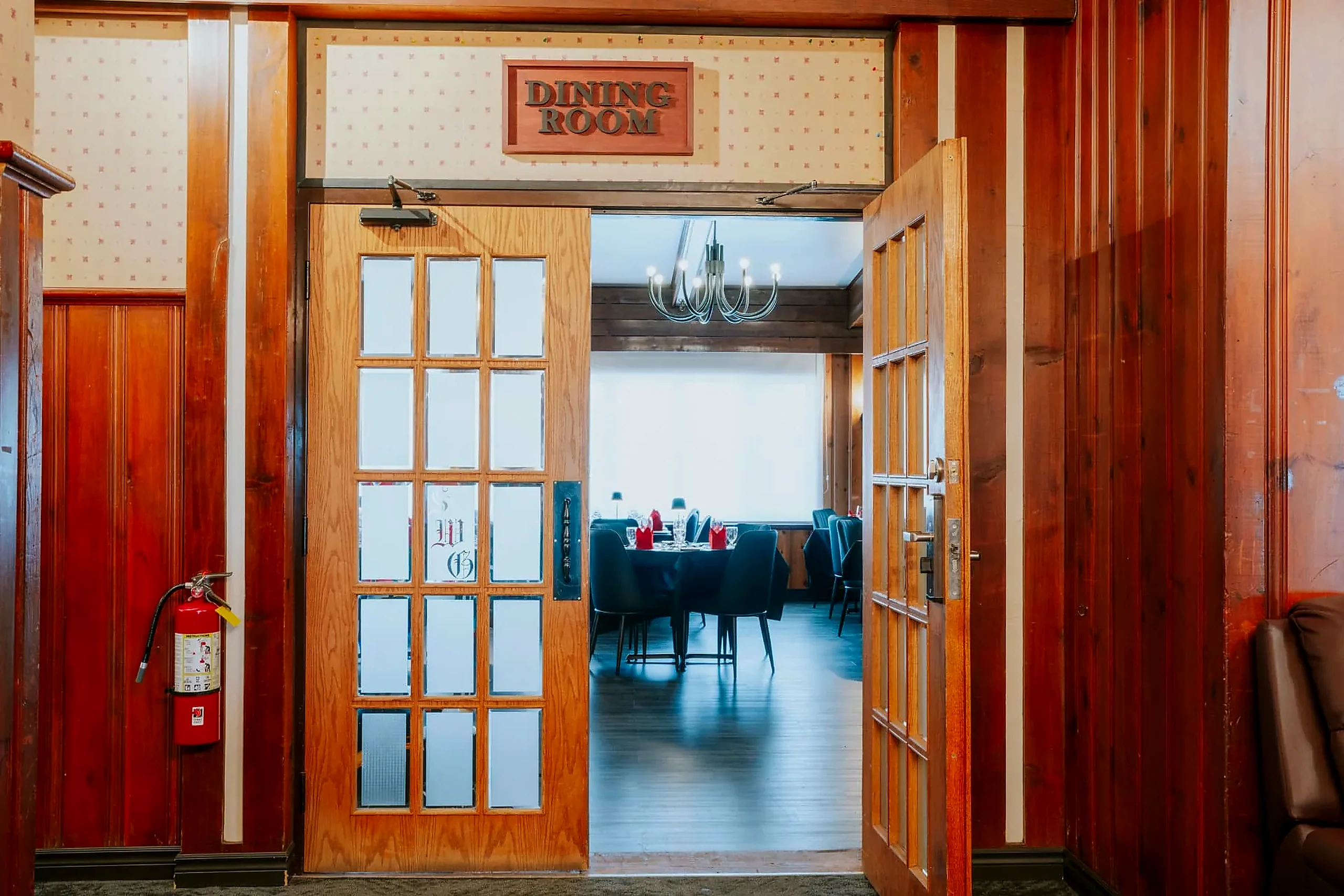 The Frozen Rooster doors opening onto tables set for service