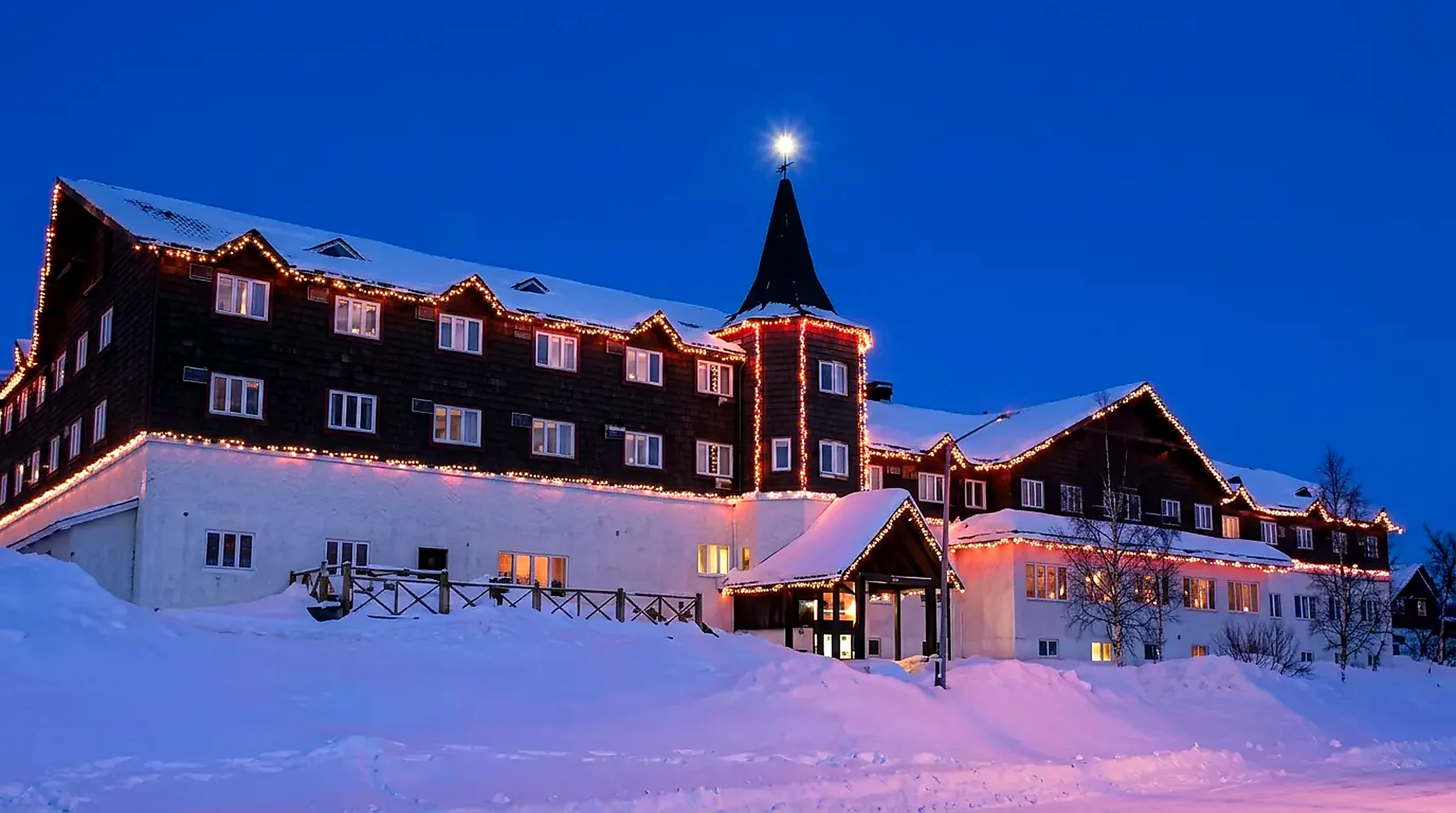 The Wabush Hotel exterior in winter, snow banked along the dark wood facade in Wabush, Labrador West