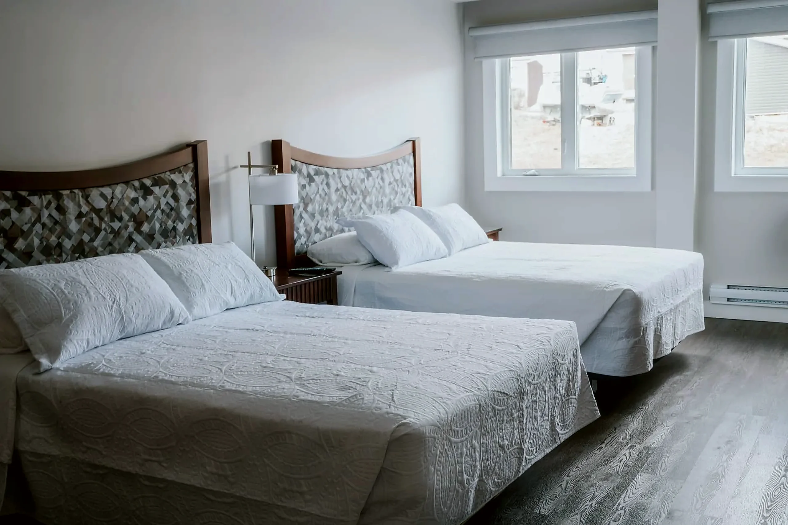 Wabush Hotel guest room with two double beds and a window, suited to two workers sharing